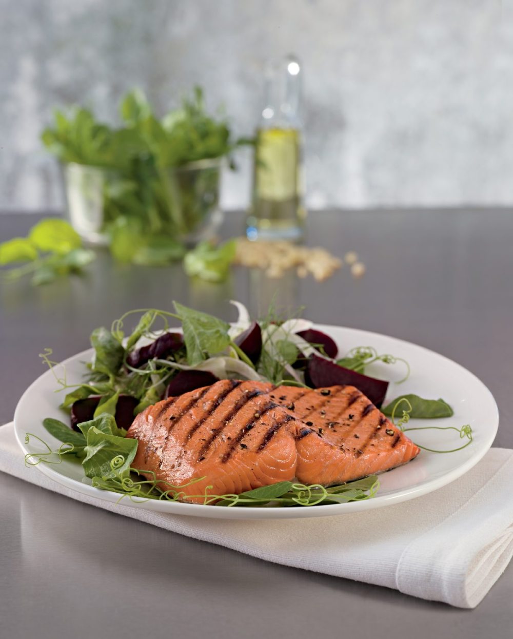 Plate of baked salmon with side salad